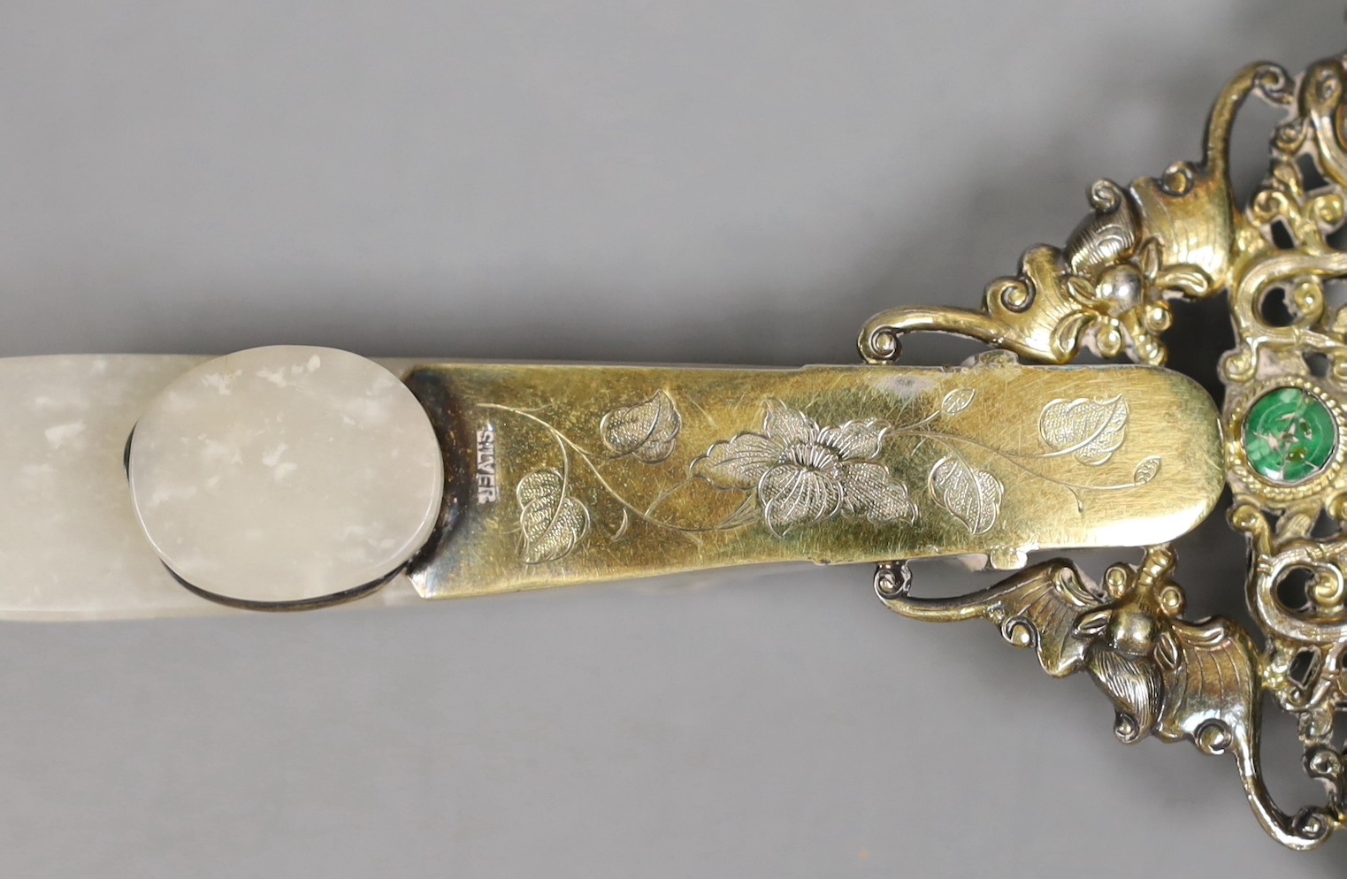 An Eastern white metal ‘SILVER’ marked magnifying glass with carved jade belt hook handle, total length 20cm